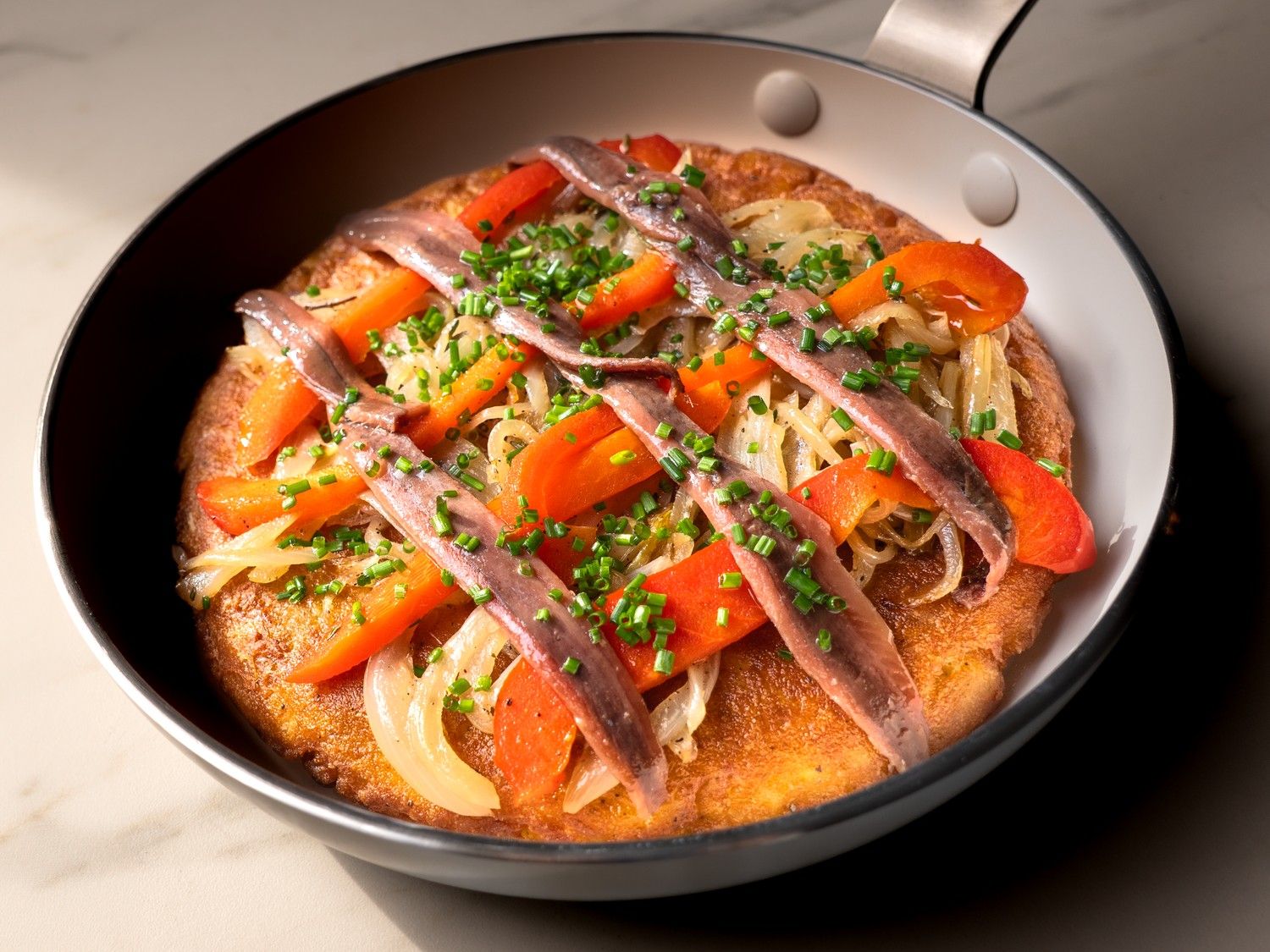 Tortilla met gestoofde ui, gekonfijte paprika en ansjovis