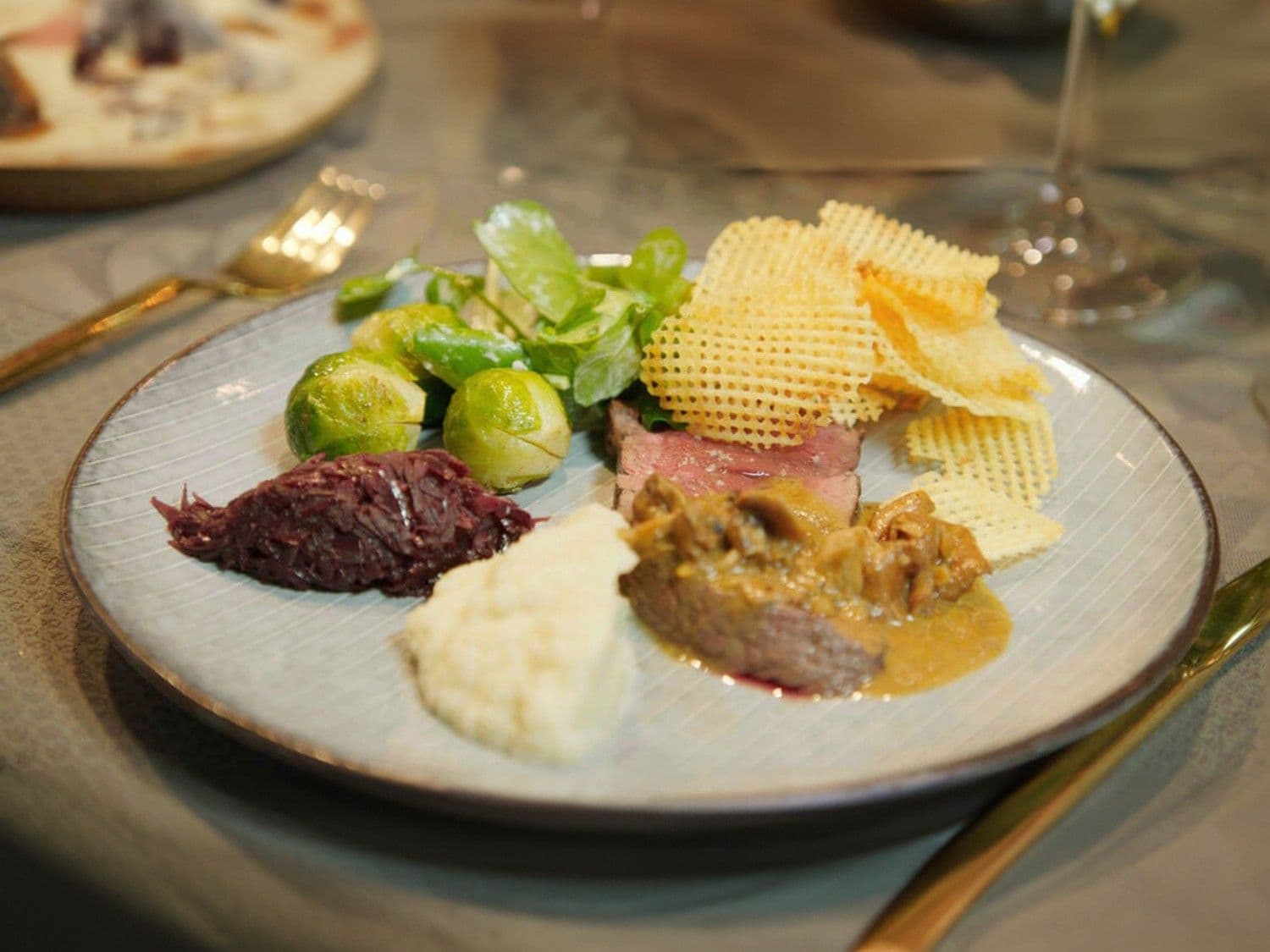 Hertengebraad met champignonsaus, rode kool, appel-knolseldermash en aardappelwafeltjes