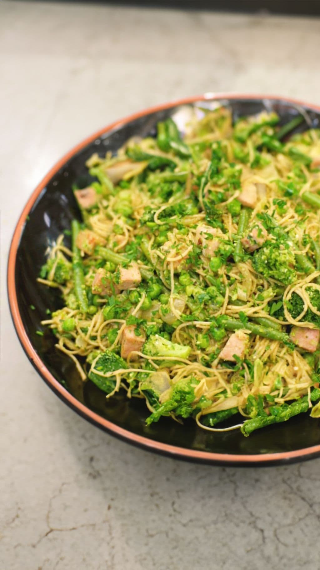 Volkoren capellini met hamblokjes, groenten en erwtenpesto